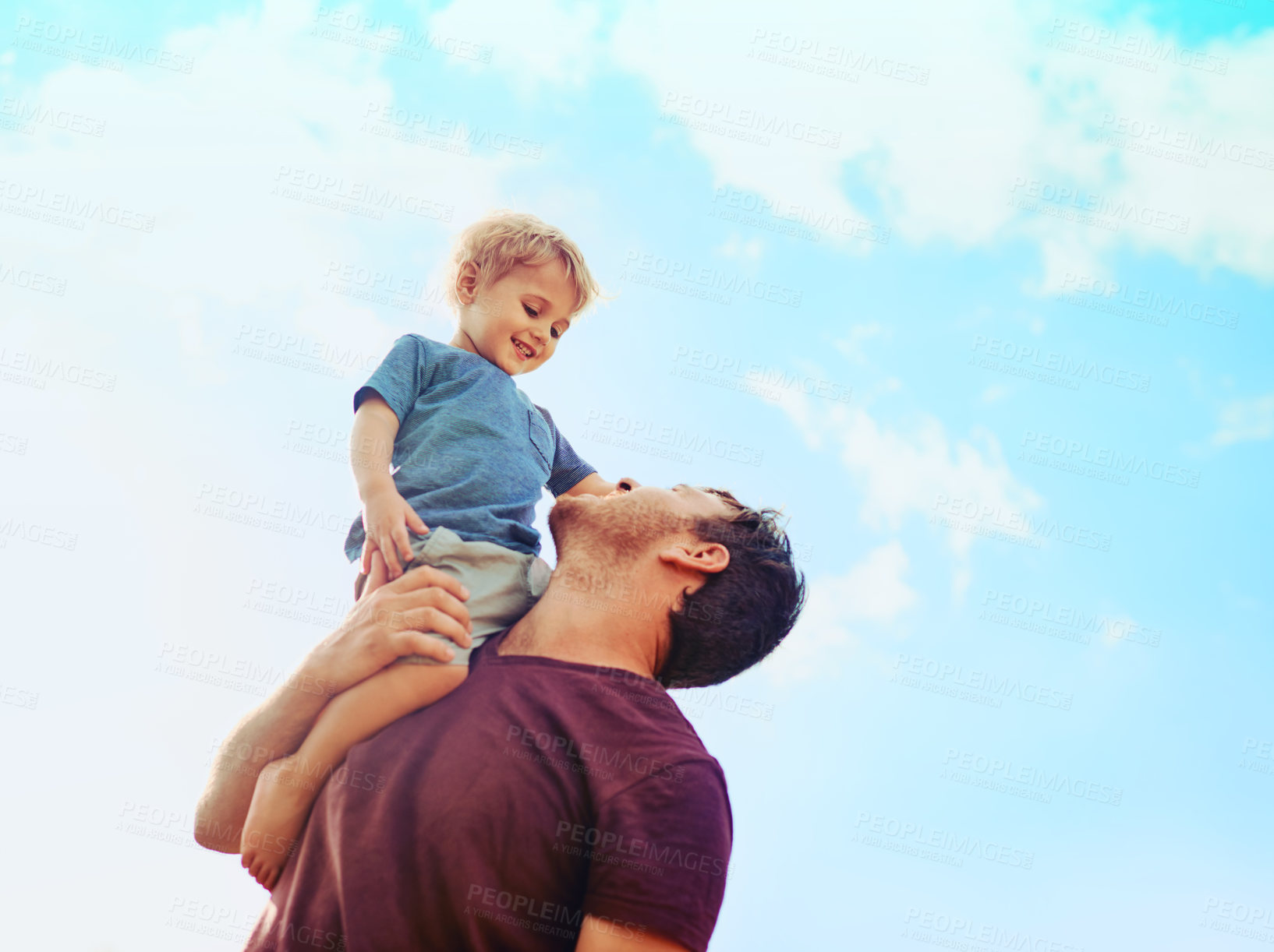 Buy stock photo Shot of a happy little boy and his father playing together in their backyard at home