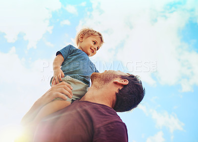 Buy stock photo Sky, smile and dad holding child for bonding, growth and development for kids in low angle. Smile, father and happy son in nature for outdoor adventure with support, love and trust on weekend morning