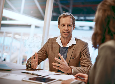 Buy stock photo Cropped shot of two businesspeople working together in the boardroom