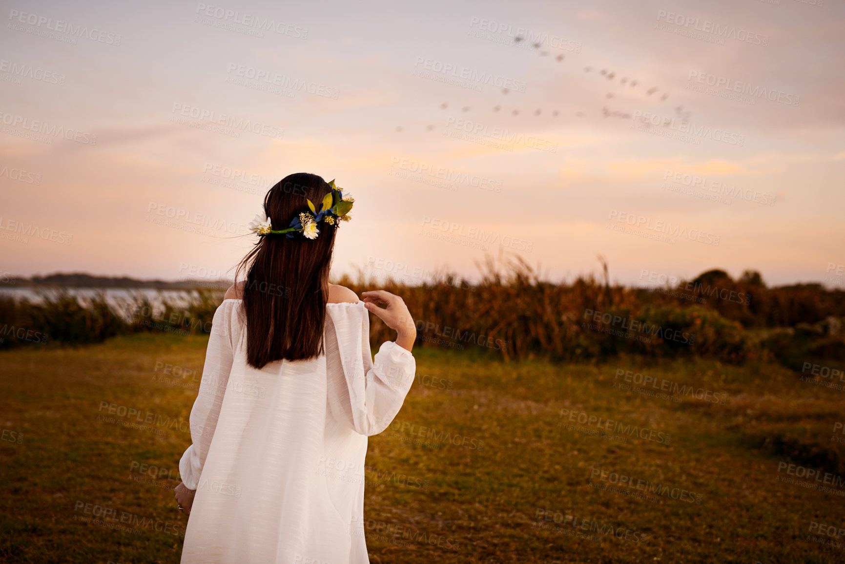 Buy stock photo Rearview shot of a young woman outdoors