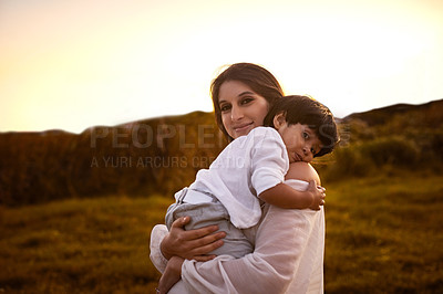 Buy stock photo Shot of a young mother holding her son outdoors
