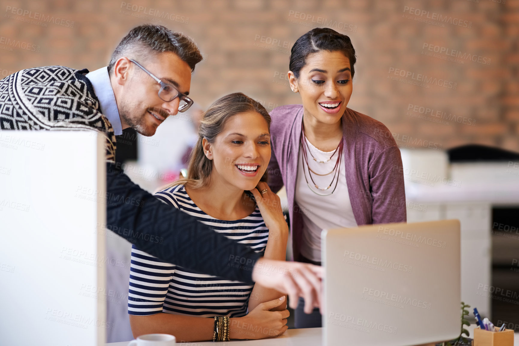 Buy stock photo Shot of a mature man helping out a work colleague on her laptop in the office