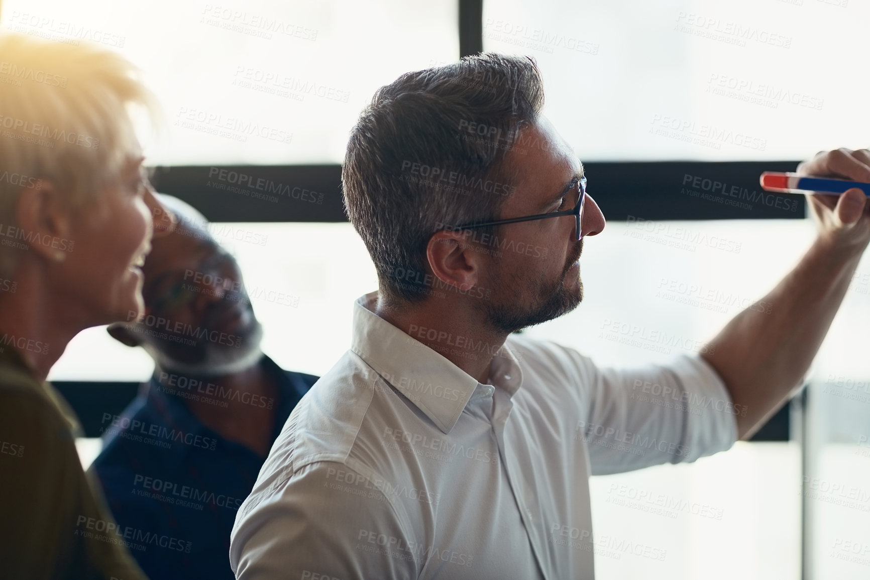 Buy stock photo Serious, mature and expert business man doing presentation, planning and talking in a meeting in a boardroom. Manager doing training workshop, teaching and coaching new employees during conference