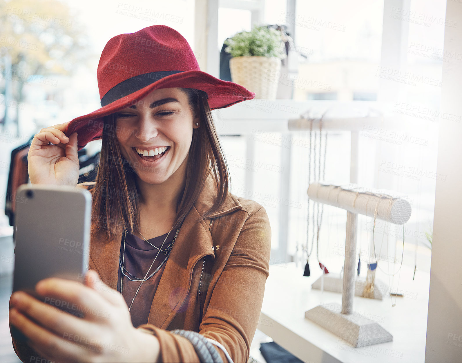 Buy stock photo Cropped shot of an attractive young woman snapping selfies while out on a shopping spree