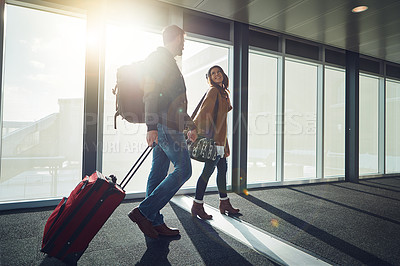 Buy stock photo Travel, couple and holding hands with suitcase, man and woman in airport, journey and smile for vacation. People, together and happiness for holiday, trip or walking for flight, excited and honeymoon