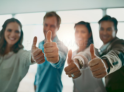 Buy stock photo Cropped shot of a motivated group of businesspeople showing thumbs up and smiling while looking at the camera
