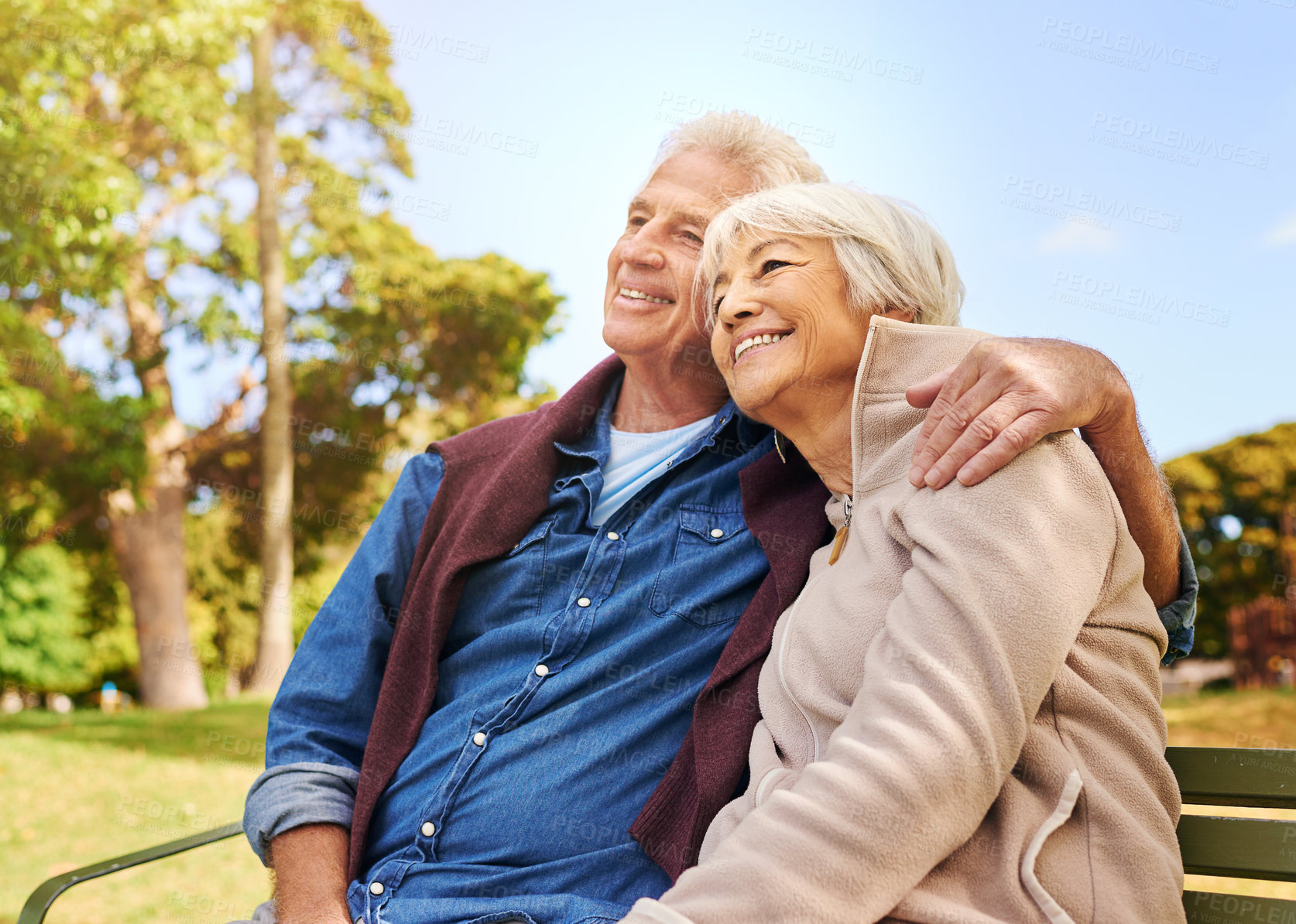 Buy stock photo Old couple, hug and relax in the park with smile, happiness together with bonding in nature, love and retirement. Happy, man and woman with travel, relationship with trust in marriage and commitment