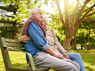 Buy stock photo Shot of a happy senior couple relaxing on a park bench