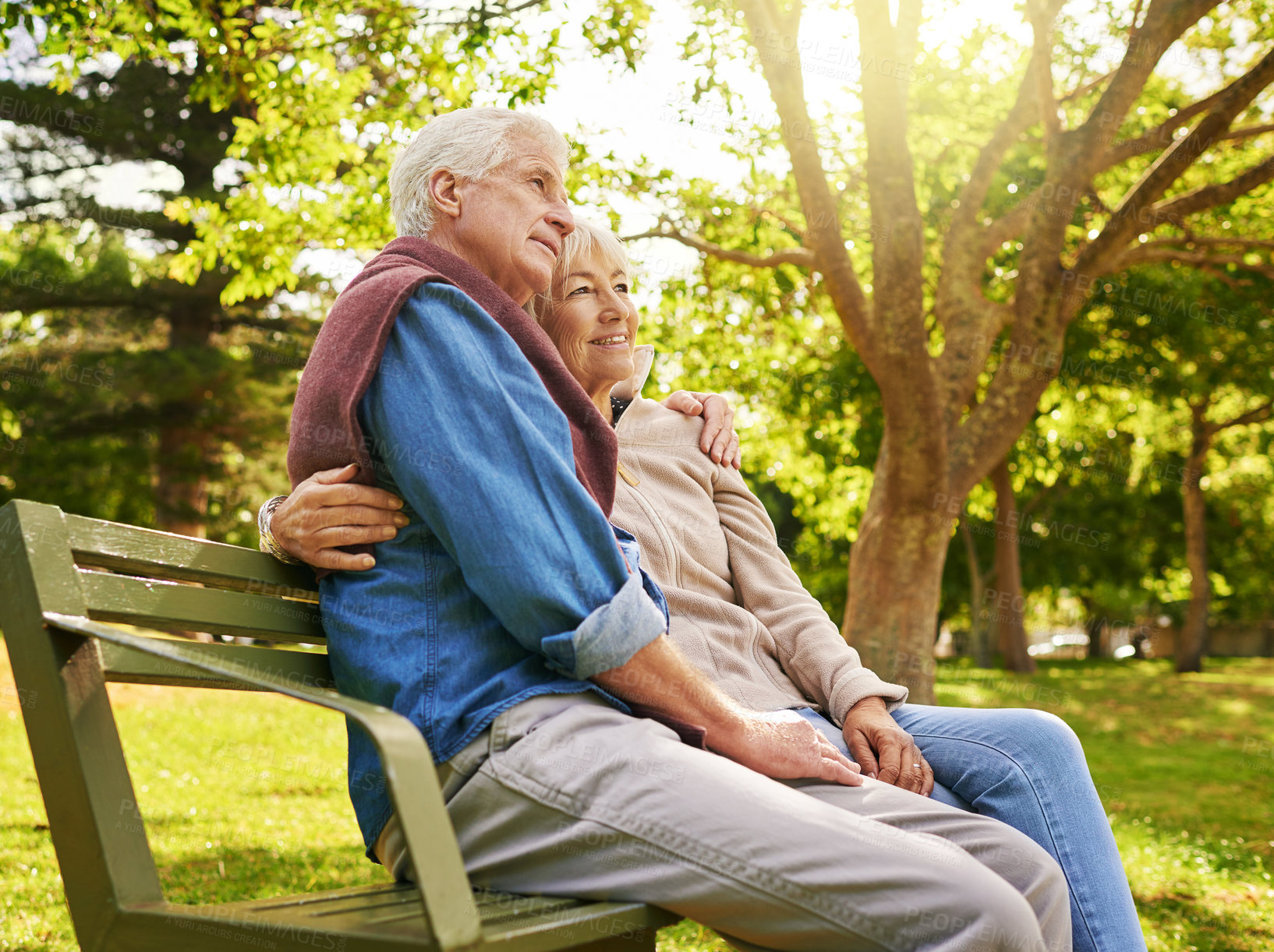 Buy stock photo Shot of a happy senior couple relaxing on a park bench