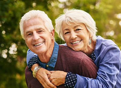 Buy stock photo Portrait of a happy senior couple enjoying a piggyback ride outdoors