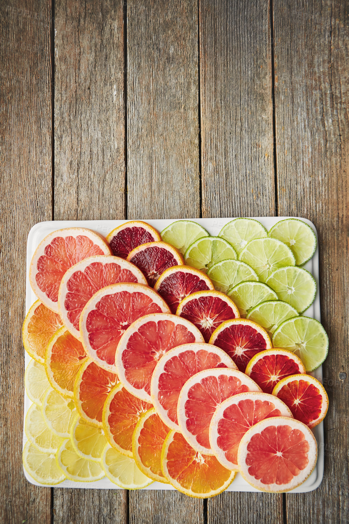 Buy stock photo Fruit slice, diet and citrus with vitamin c benefits for healthy vegan nutrition and ingredients on plate. Natural product, food and grapefruit with orange for wellness and top view on wood table