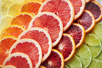 Buy stock photo Shot of a variety of citrus fruits cut into slices