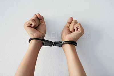 Buy stock photo Hands, restriction and person with handcuffs by white wall for mental health, anxiety and struggle. Depression, captivity and wrist with shackle for internal prison, control and psychological barrier