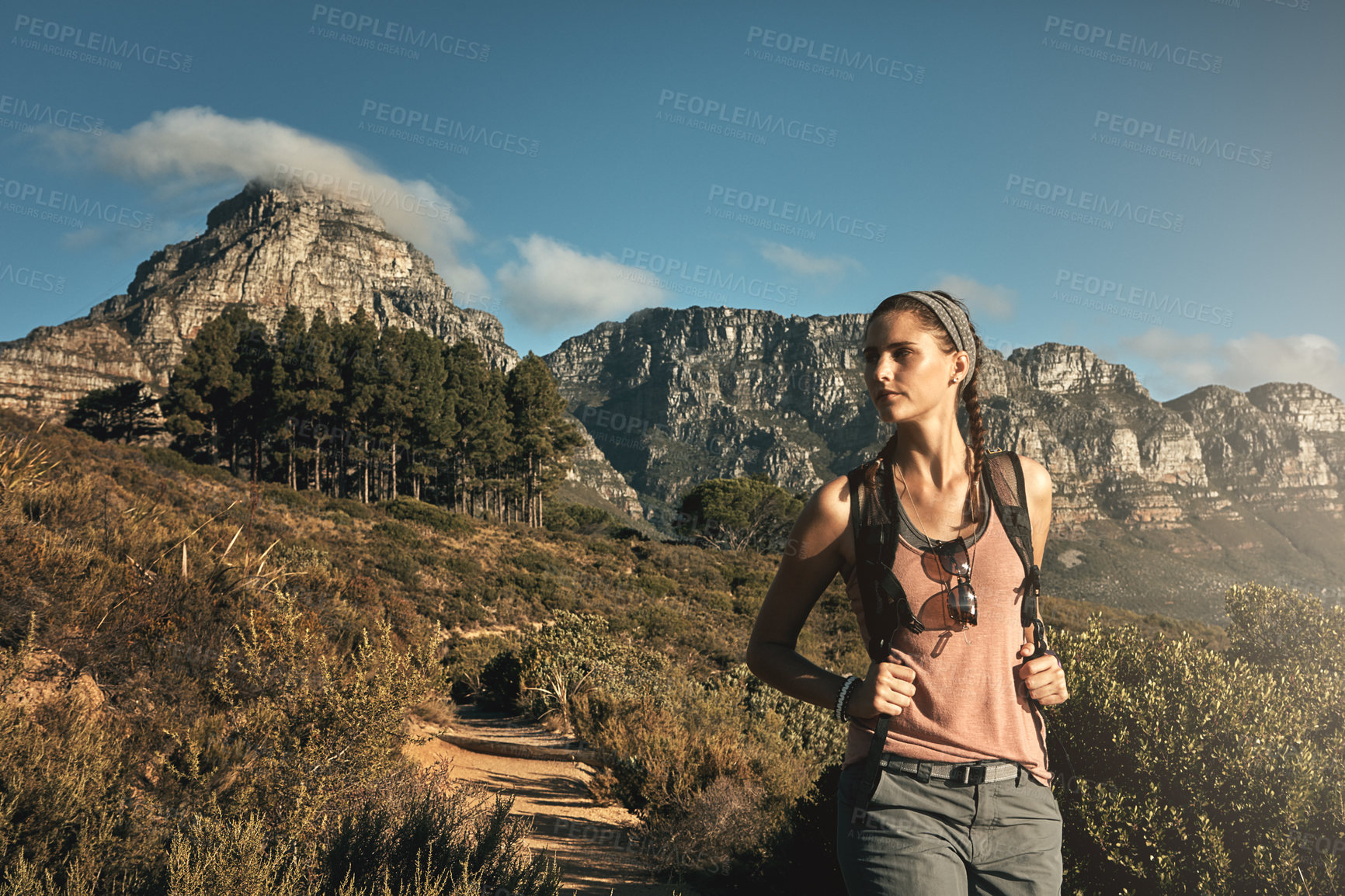 Buy stock photo Shot of a young woman out on a hike through the mountains