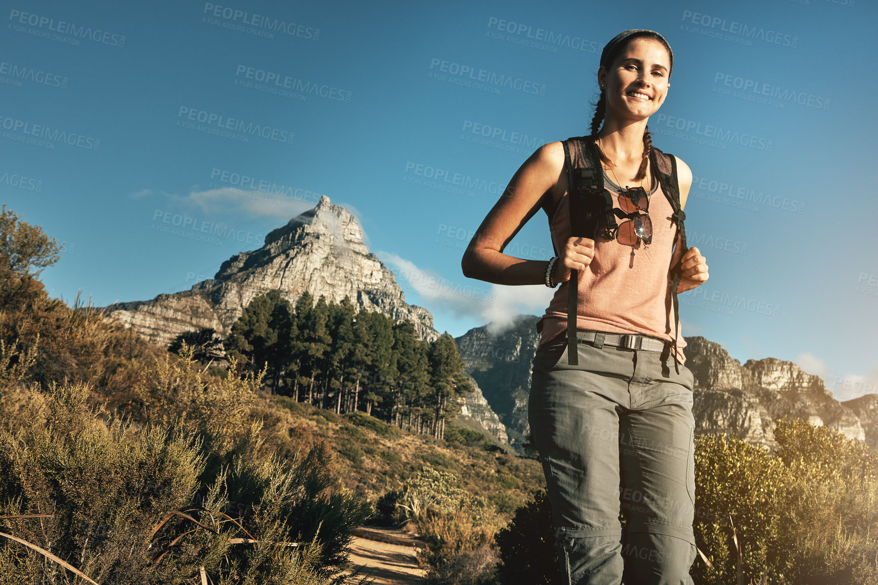 Buy stock photo Portrait of a young woman out on a hike through the mountains