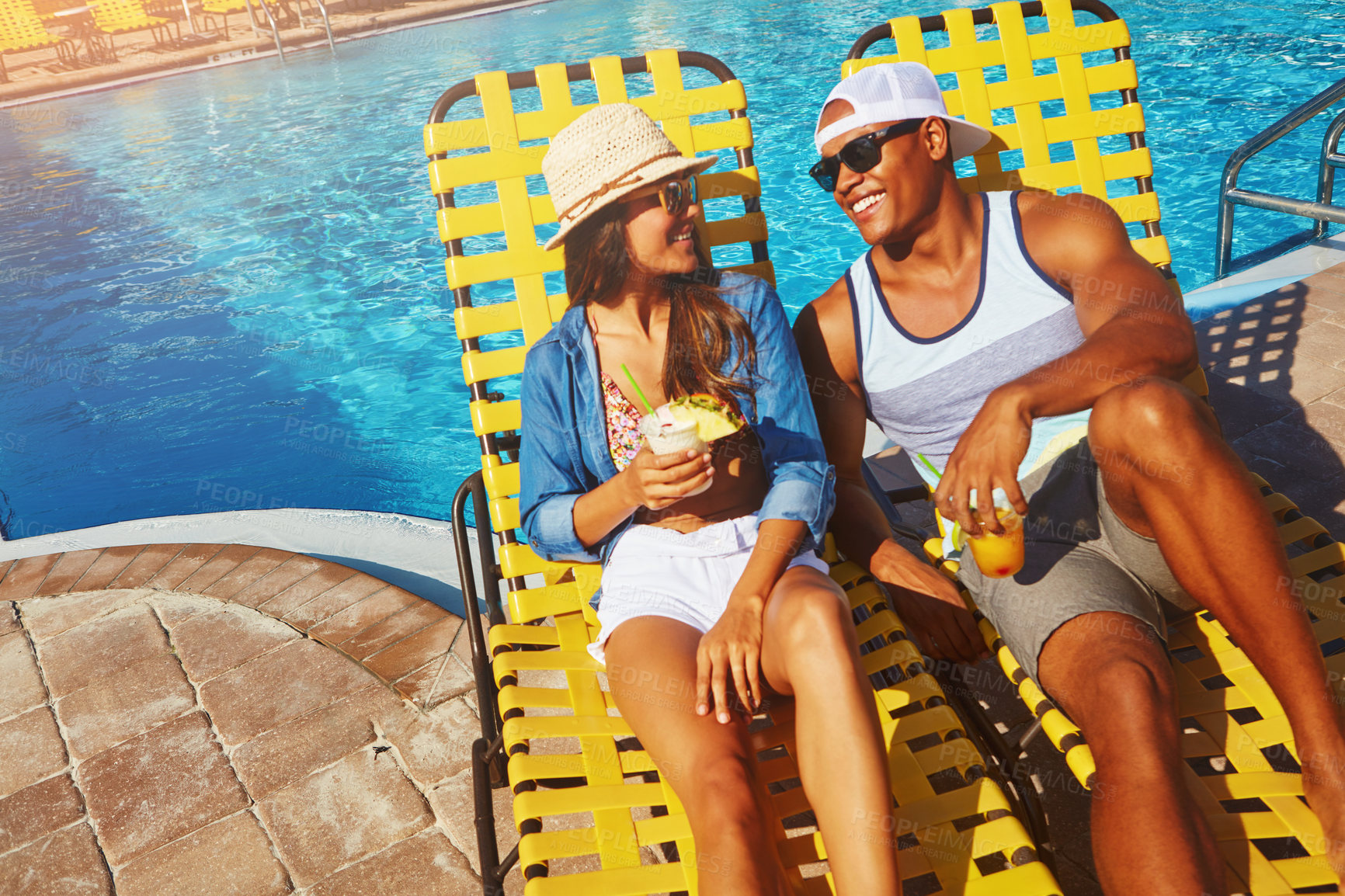 Buy stock photo Couple, poolside and alcohol on holiday trip, outdoor and travel to hotel resort for vacation. People, peace and sunglasses by water for drinks, bonding and relax by swimming pool for wellness