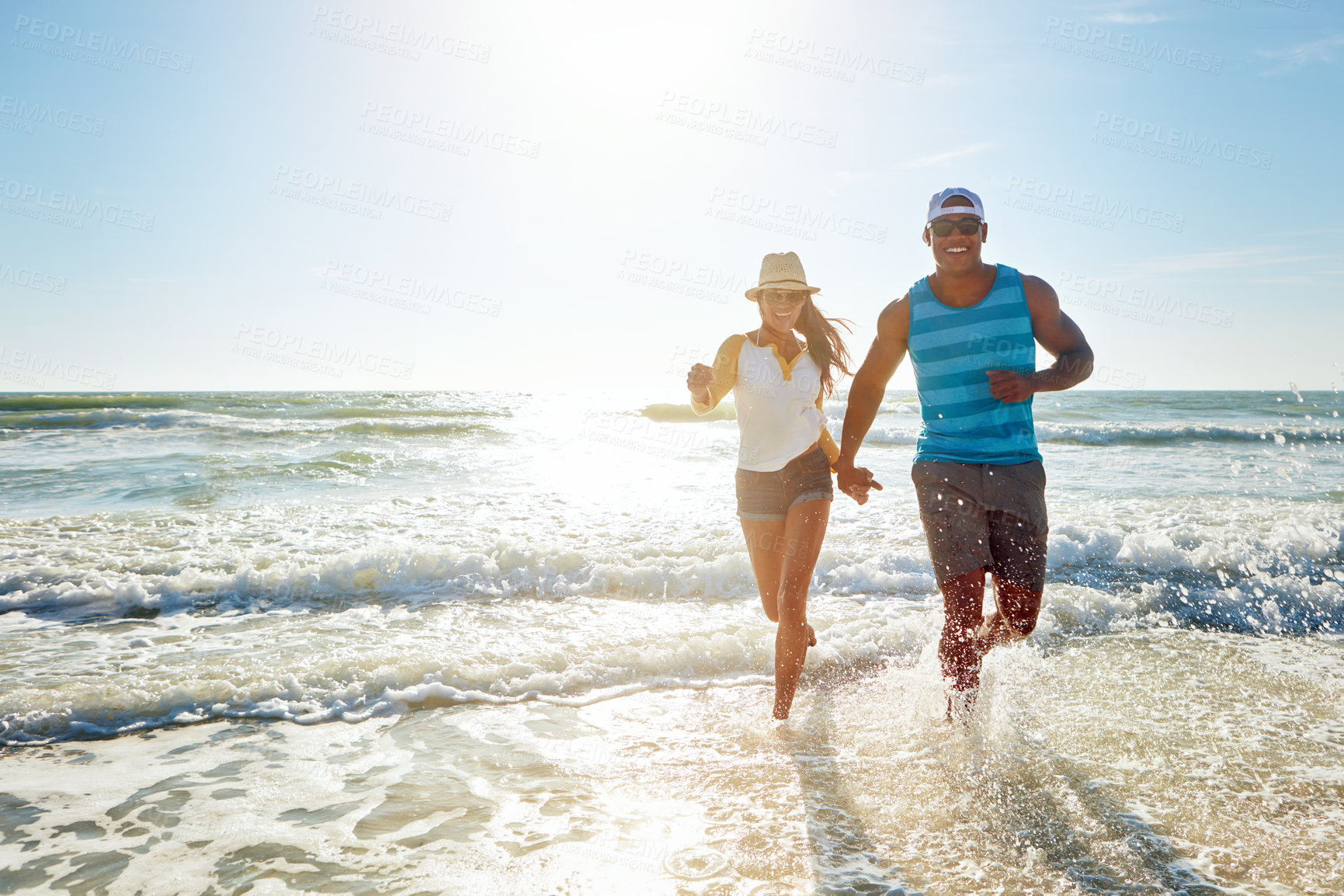 Buy stock photo Couple, running and holding hands on beach for outdoor romance, holiday and vacation in summer. Excited people in water splash with love, fun or energy for travel, health or wellness in sea portrait