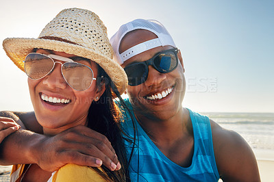 Buy stock photo Portrait of a young couple sitting on the beach on a sunny day