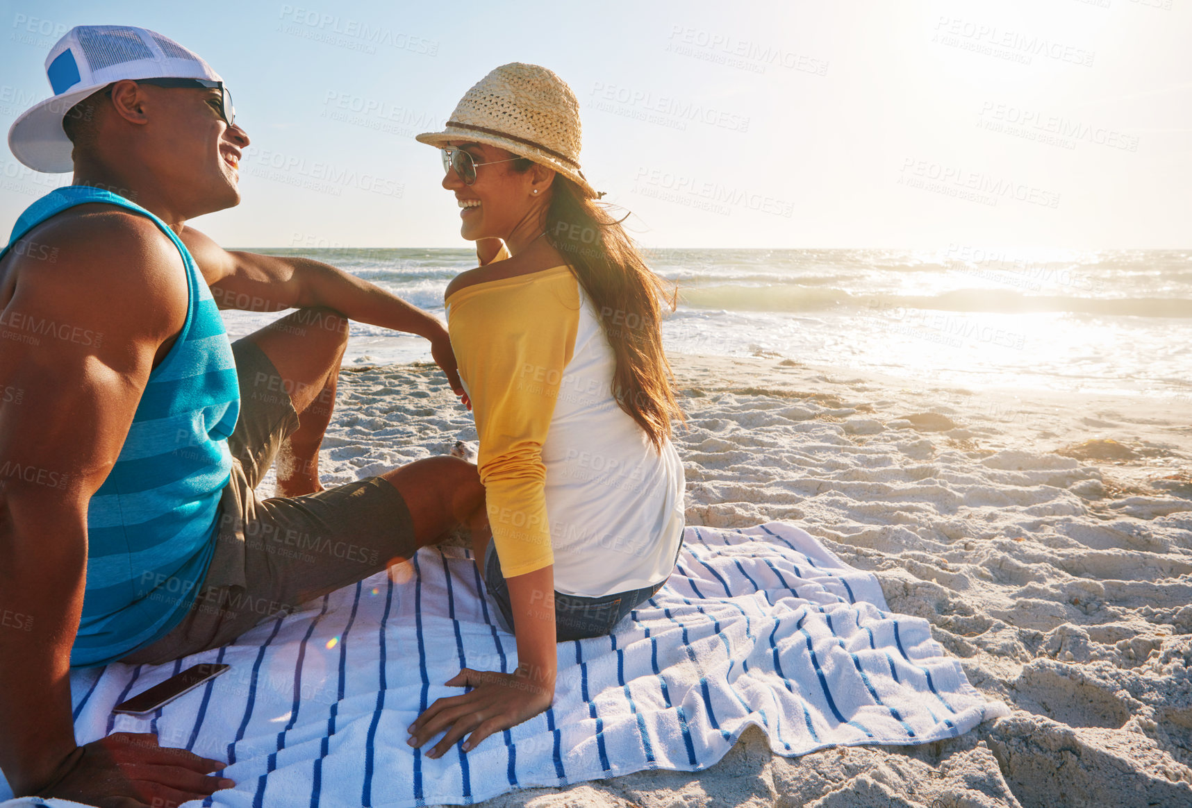 Buy stock photo Love, relax and couple with sunglasses on beach for adventure, holiday and bonding with laugh. Outdoor, towel and seaside with happy people, boyfriend and girlfriend for sunset on vacation in Bali