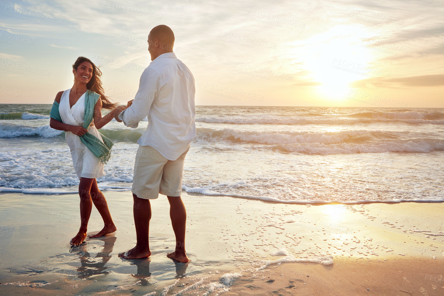 Buy stock photo Shot of a romantic couple dancing on the beach at sunset