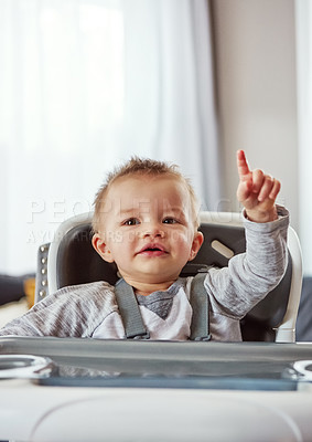 Buy stock photo Baby, high chair and house in portrait for development or wellness, motor skills with finger for growth. Young, boy child and hand in home for healthy learning, waiting for meal time in apartment