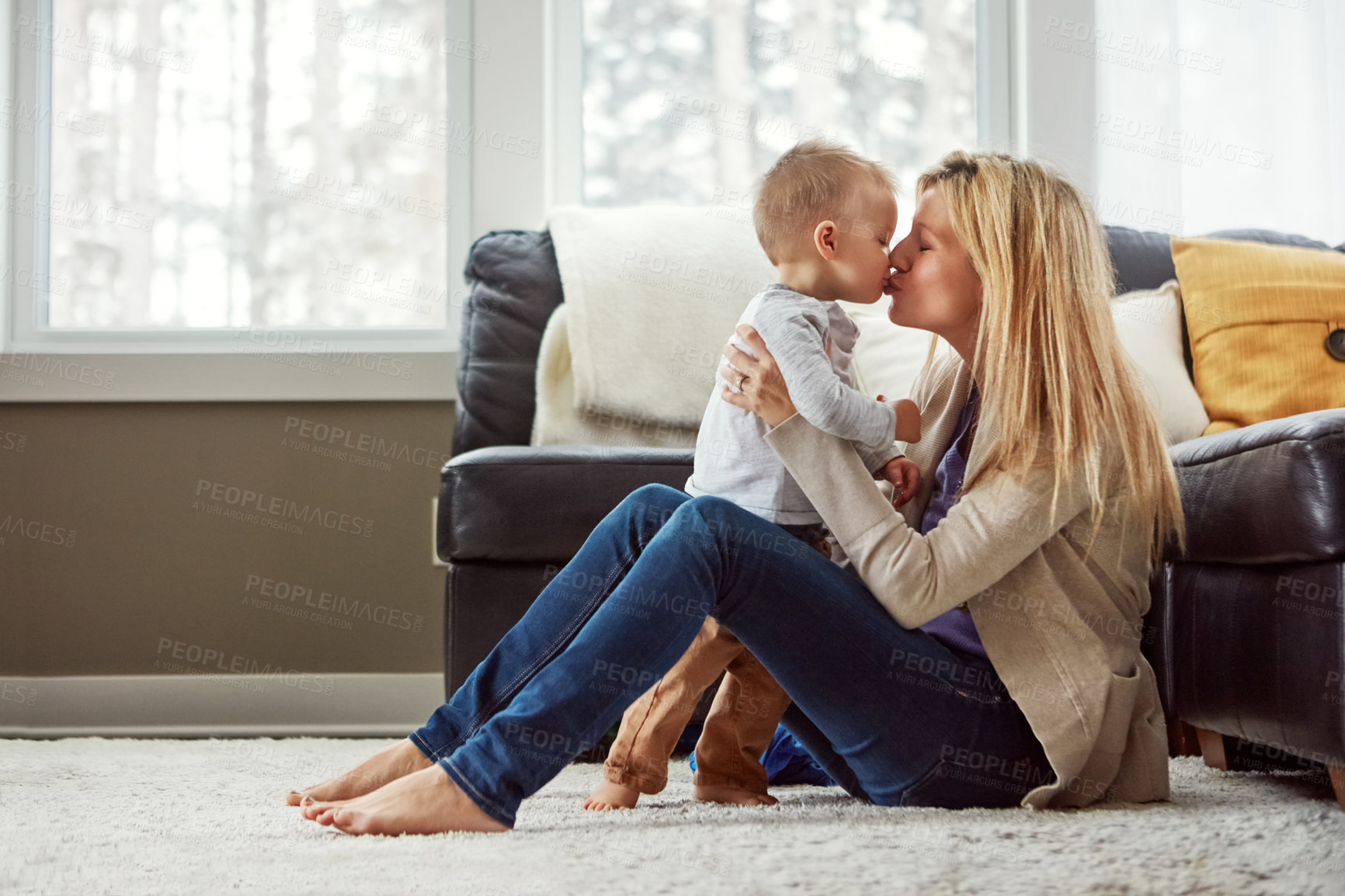 Buy stock photo Home, love and kiss of baby by mom, living room and playful with son, embrace and care in apartment. House, mother and toddler in lounge, hug and together on floor, happiness and wellness for boy