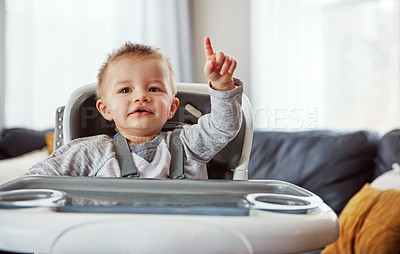 Buy stock photo Baby, high chair and house with happiness for learning or wellness, motor skills with finger for development. Young, boy child and hand in home for healthy growth, waiting for meal time in apartment