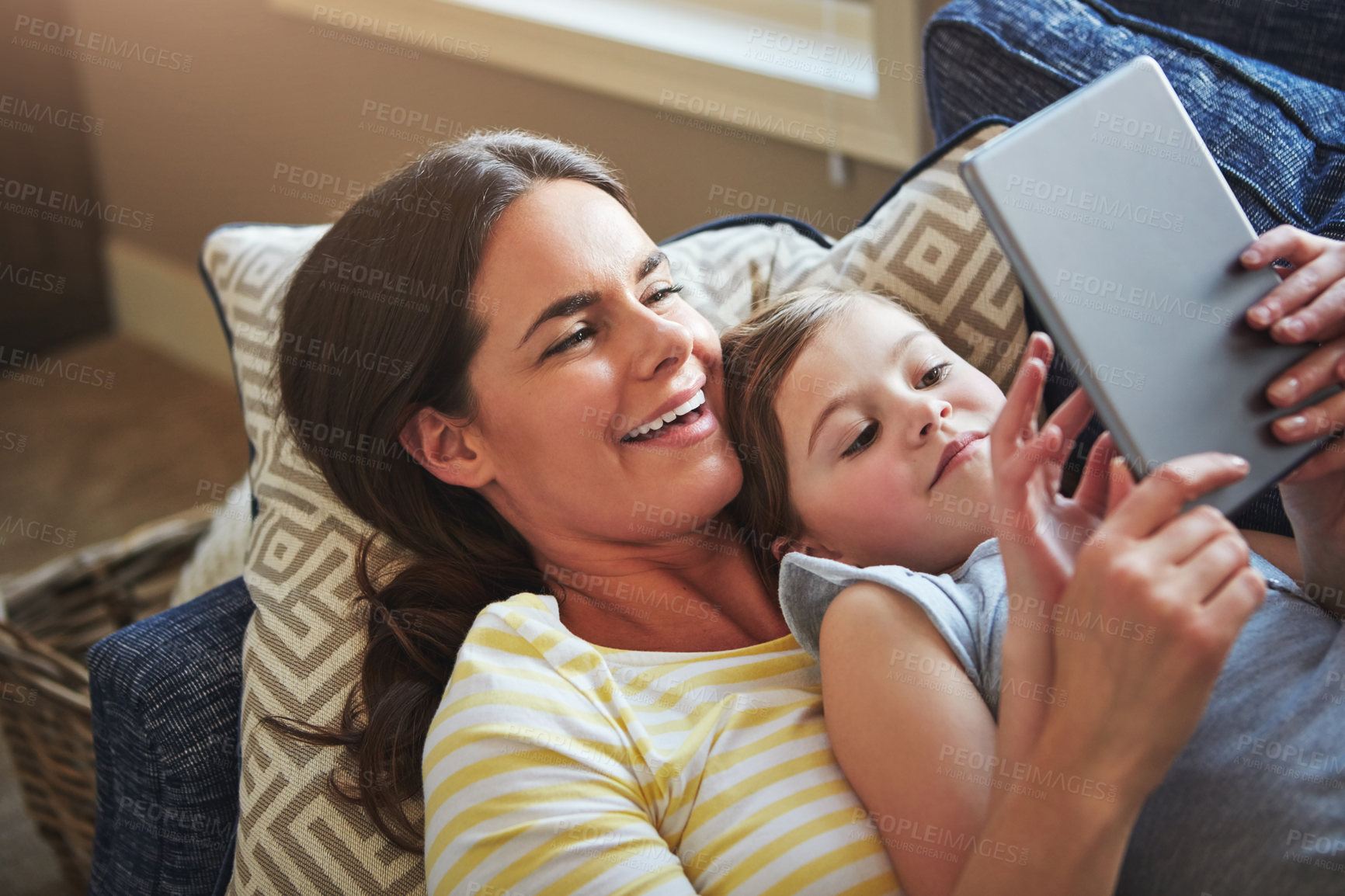 Buy stock photo Tablet, mother and girl on sofa with internet for reading ebook, relationship love and streaming animation for fun in home. Child, mama and tech on couch with website for learning language and games