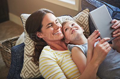 Buy stock photo Tablet, mother and girl on couch with internet for reading ebook, relationship love and streaming animation movie in home. Child, mama and tech on sofa with website for learning language and gaming