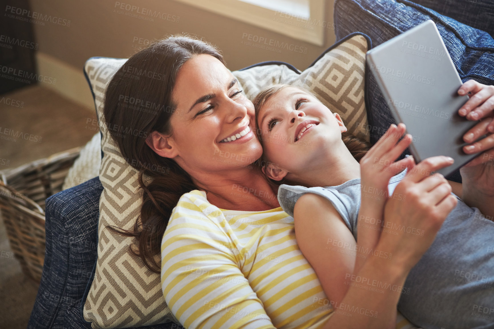 Buy stock photo Tablet, mother and girl on couch with internet for reading ebook, relationship love and streaming animation movie in home. Child, mama and tech on sofa with website for learning language and gaming