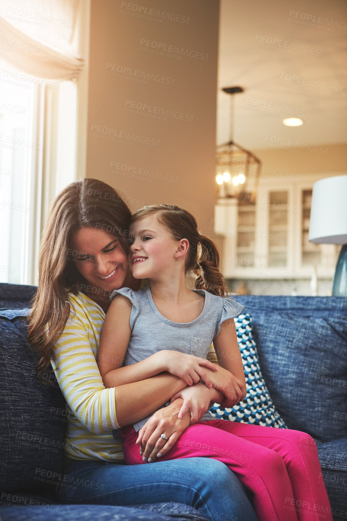 Buy stock photo Happy, woman and child hug with love on sofa for trust, bonding and support of relationship moment. Smile, mother and girl as family for care, security or relax with embrace on couch for childhood