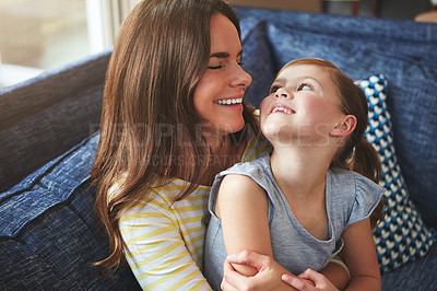 Buy stock photo Mother, child and hug with love on sofa house for playful, bonding and support of relationship moment. Smile, woman and girl as family for care, security or relax with embrace on couch for childhood