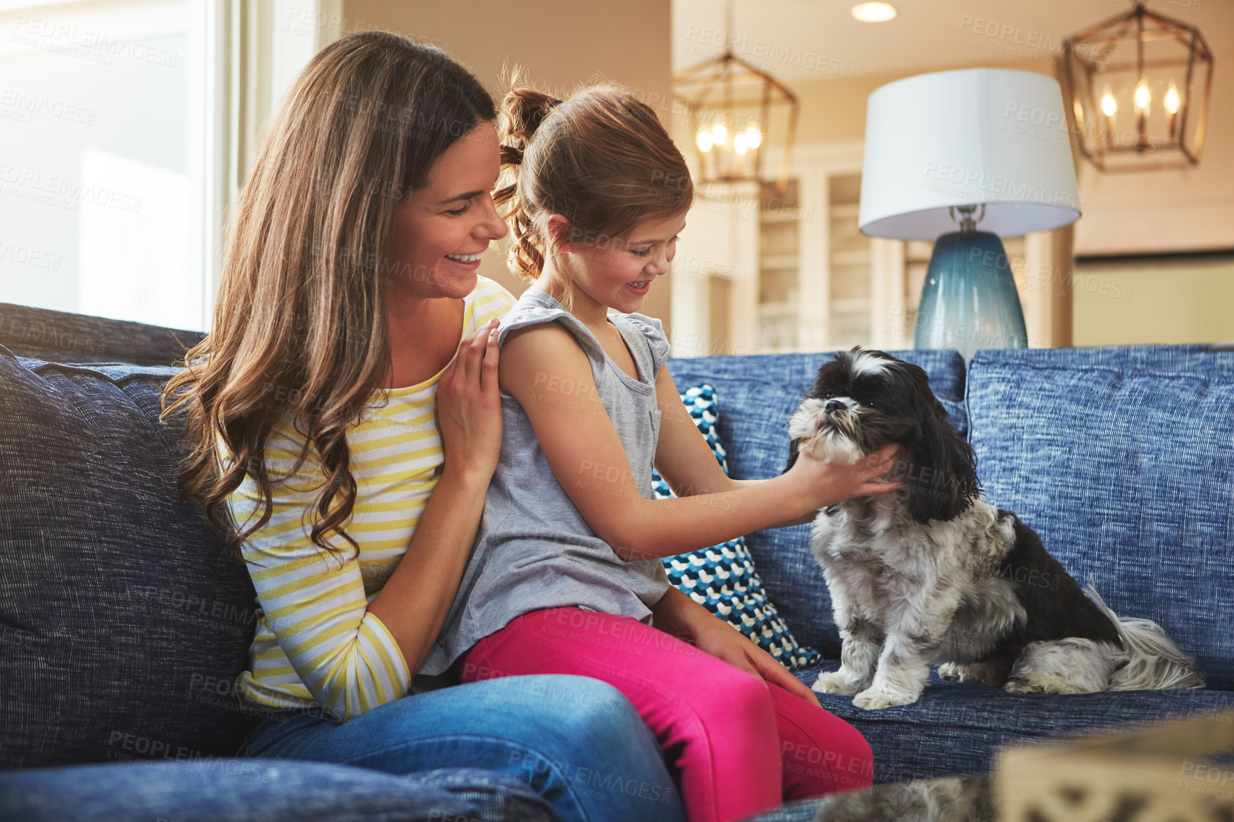 Buy stock photo Shot of an adorable little girl, her mother and their dog spending time together at home