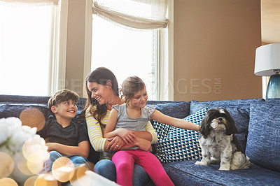 Buy stock photo Shot of a mother bonding with her little son and daughter at home
