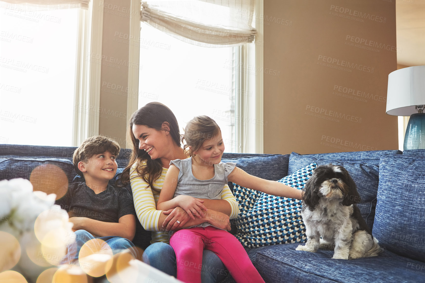 Buy stock photo Shot of a mother bonding with her little son and daughter at home