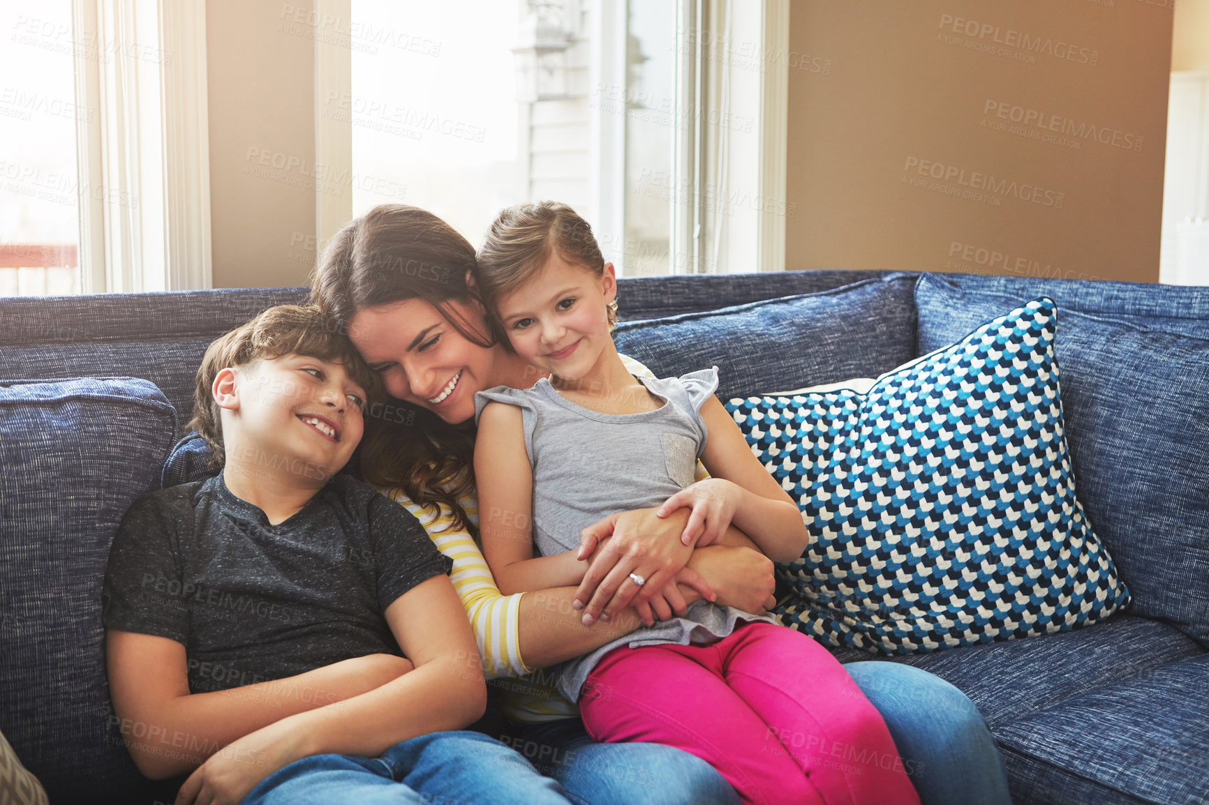 Buy stock photo Shot of a mother bonding with her little son and daughter at home