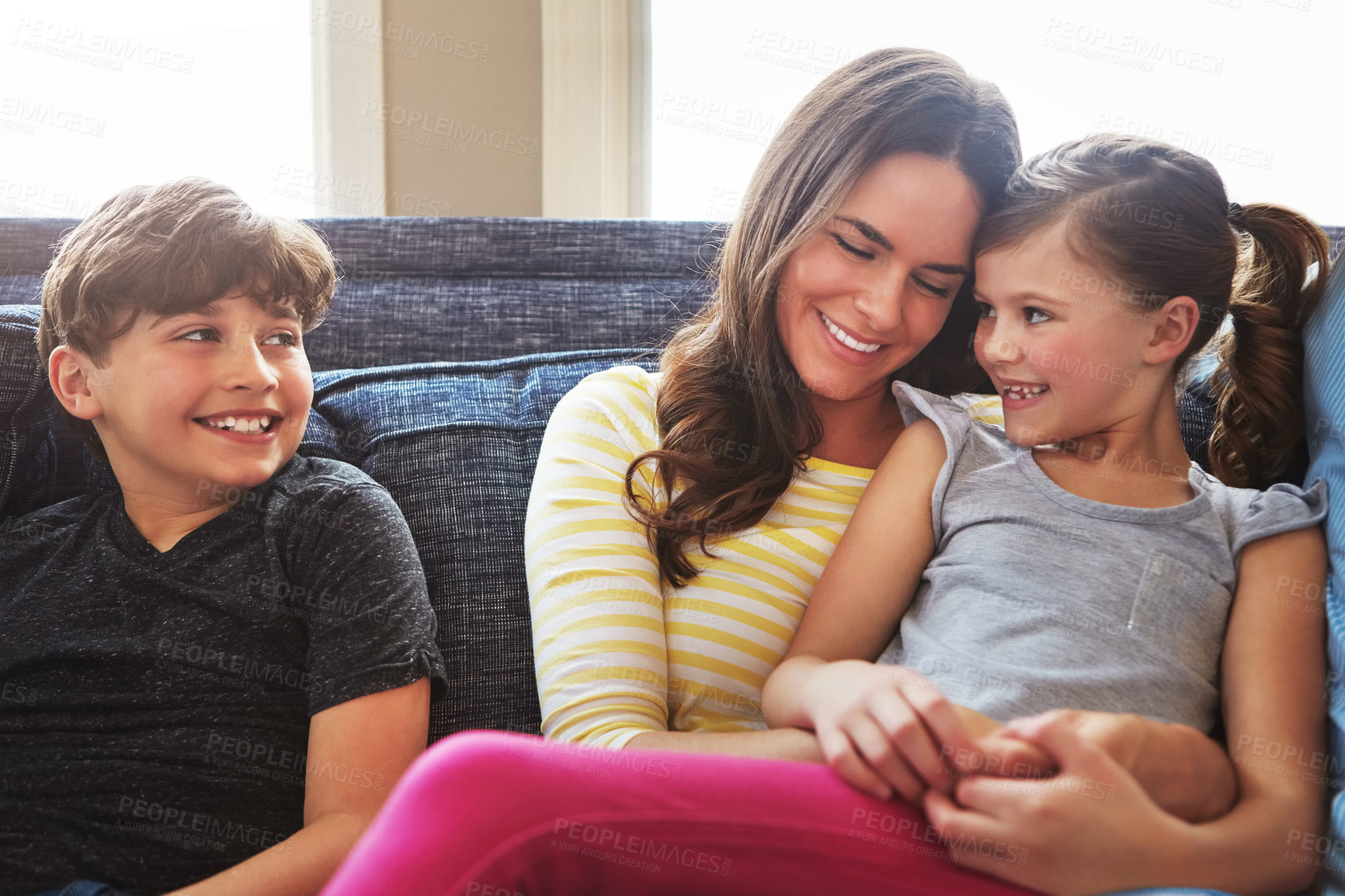 Buy stock photo Shot of a mother bonding with her little son and daughter at home