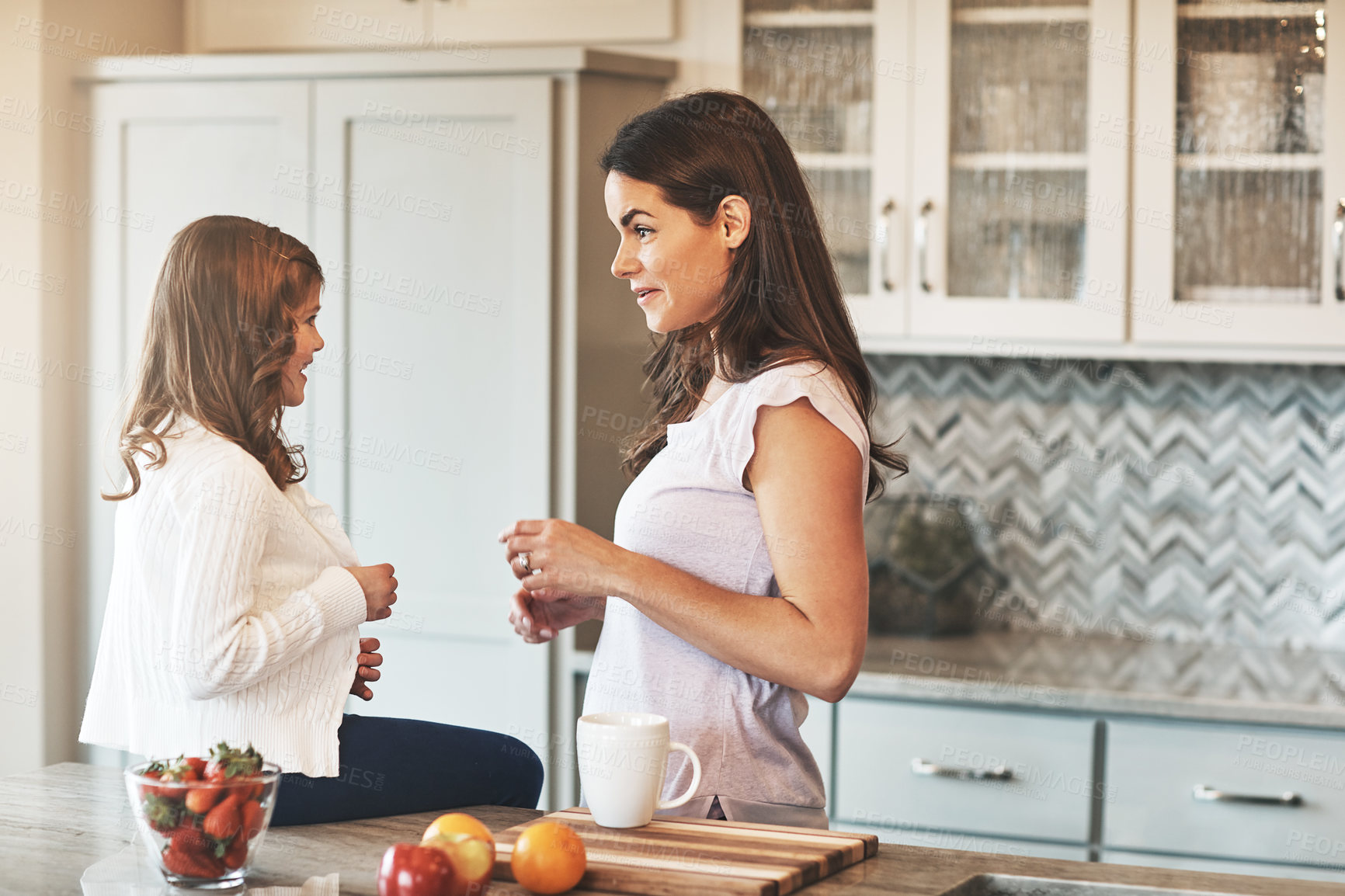 Buy stock photo Counter, mother and chat with girl, kitchen or bonding in weekend, house and kid with smile. Home, child and mom with daughter, talking and together in morning, peace or happiness in apartment