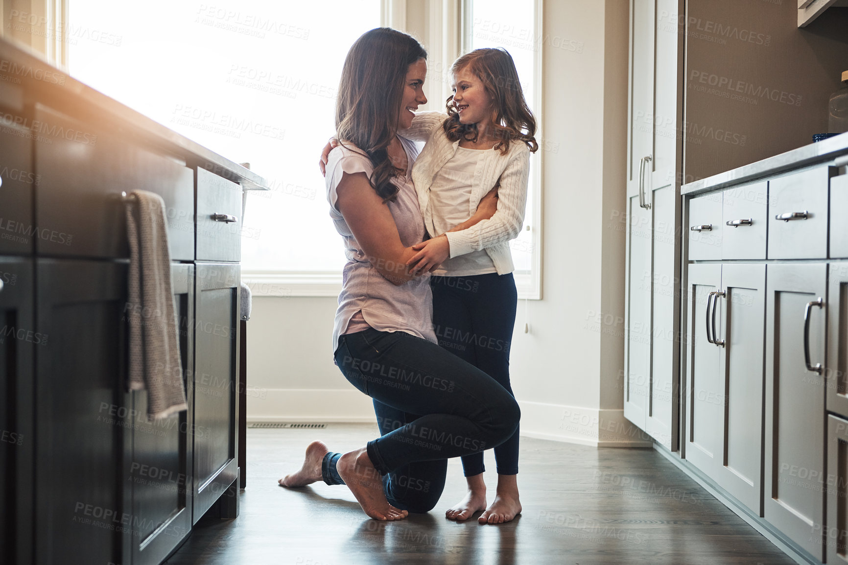 Buy stock photo Together, mom and embrace with girl, kitchen or smile in weekend, house and kid with love. Bonding, child and mother with daughter, hug and care in morning, happy or relax in apartment for peace