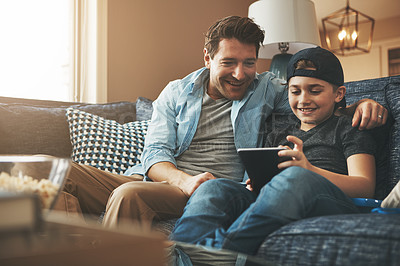 Buy stock photo Dad, child and family on sofa with tablet for online streaming service, movies or funny games on holiday. Happy man on fathers day with son on digital tech for website, support and teaching at home