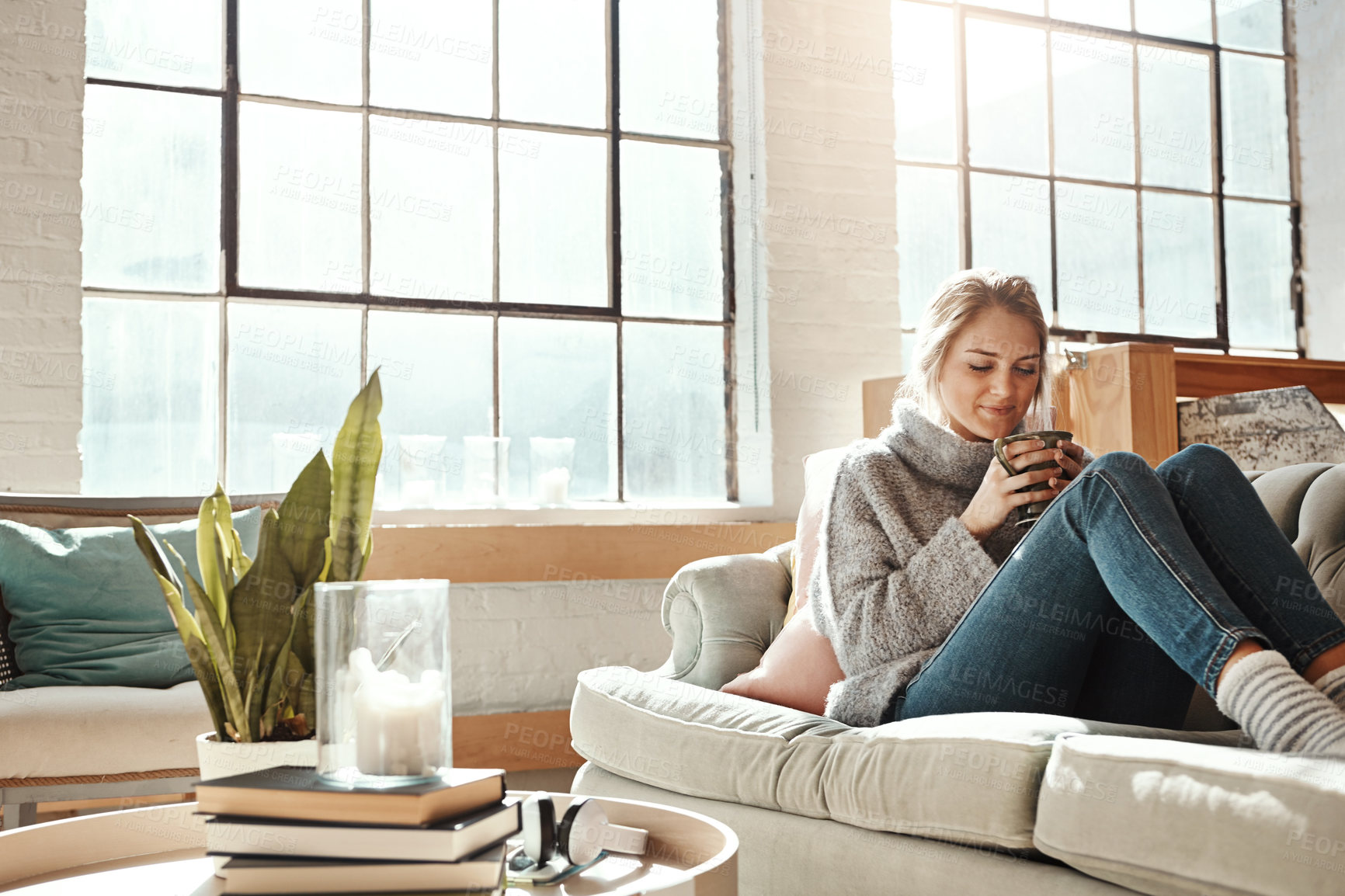 Buy stock photo Woman relax in living room, coffee and peace on sofa, content at home with lifestyle and happiness. Female in apartment, happy woman and coffee cup, positive energy and mindset with wellness