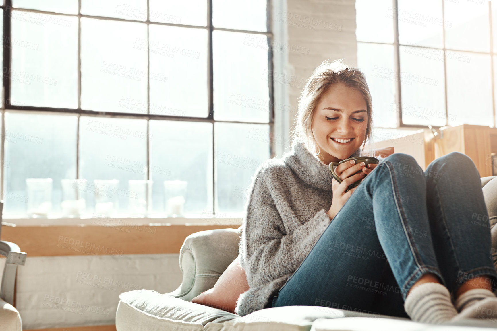 Buy stock photo Woman on sofa, coffee and relax for happiness, break and on weekend for solitude, home and living room. Young female, girl or tea in lounge on couch, comfortable or smile with drink, house and casual