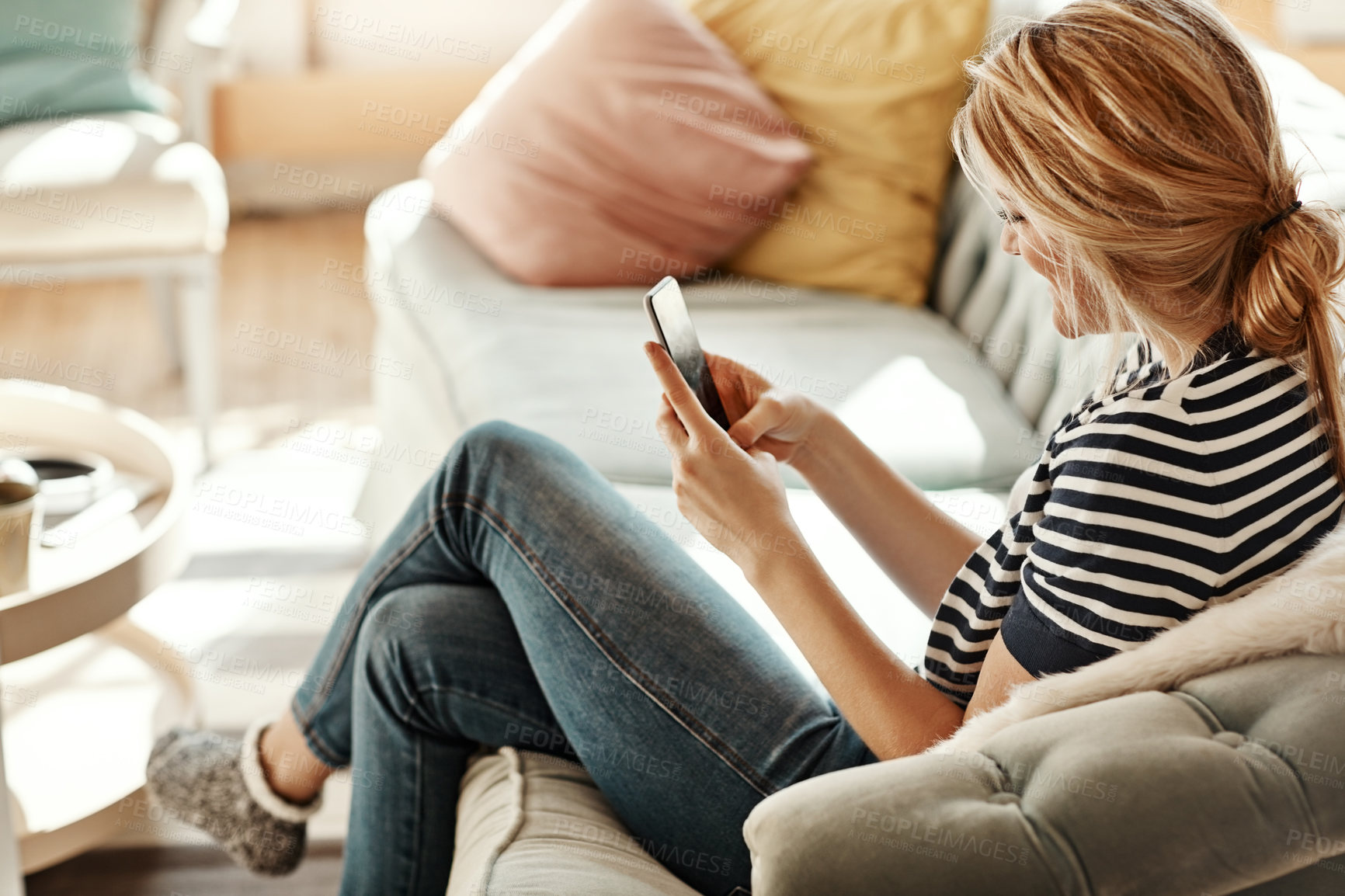 Buy stock photo Woman smile, home and phone typing of a person on a sofa with wifi busy with social media. Living room, relax and online mobile reading or scroll with connectivity and mobile phone communication