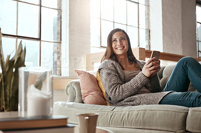 Buy stock photo Sofa, smile and woman with phone in house for social media, notification and communication. Happy, relax and person thinking with tech in living room for internet, connection and update on blog