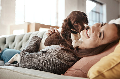 Buy stock photo Smile, relaxing and woman with dog on sofa bonding with pet in living room at apartment. Happy, animal and female person cuddle, hug and embrace puppy with love and care on couch in lounge at home.