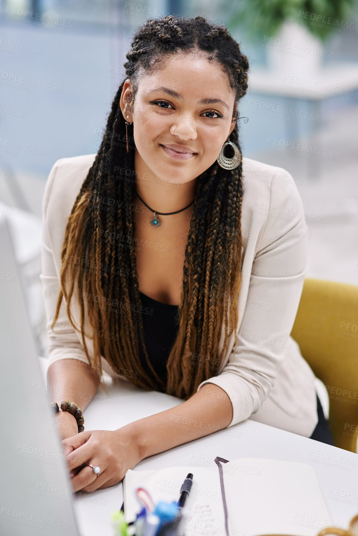 Buy stock photo High angle portrait of an attractive young businesswoman sitting at her desk in the office