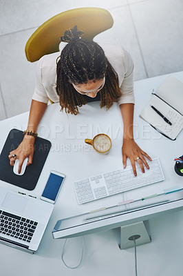 Buy stock photo High angle shot of a young businesswoman working at her desk in the office