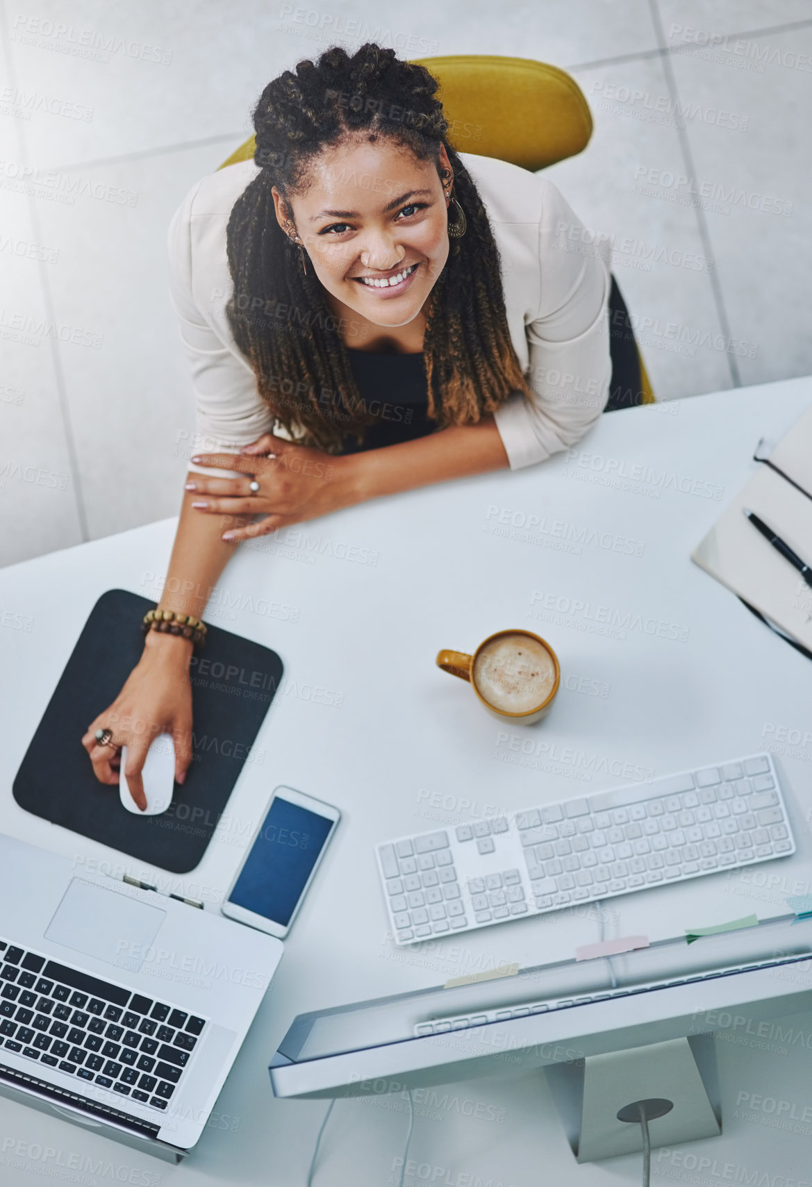 Buy stock photo High angle portrait of an attractive young businesswoman working at her desk in the office