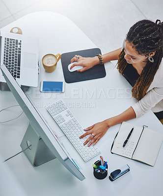 Buy stock photo High angle shot of a young businesswoman working at her desk in the office