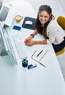 Buy stock photo High angle portrait of an attractive young businesswoman sitting at her desk in the office